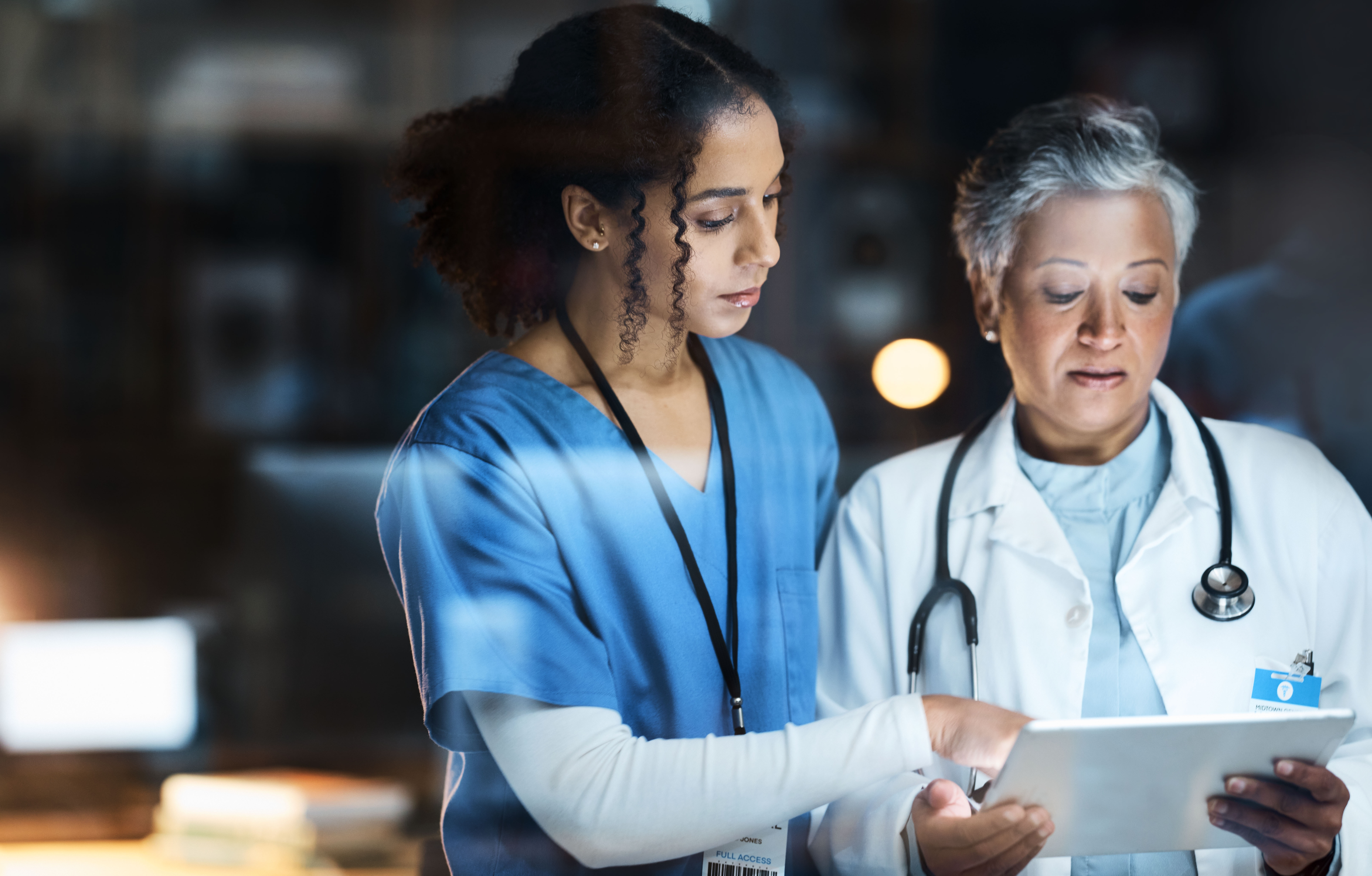 female healthcare professionals using tablet