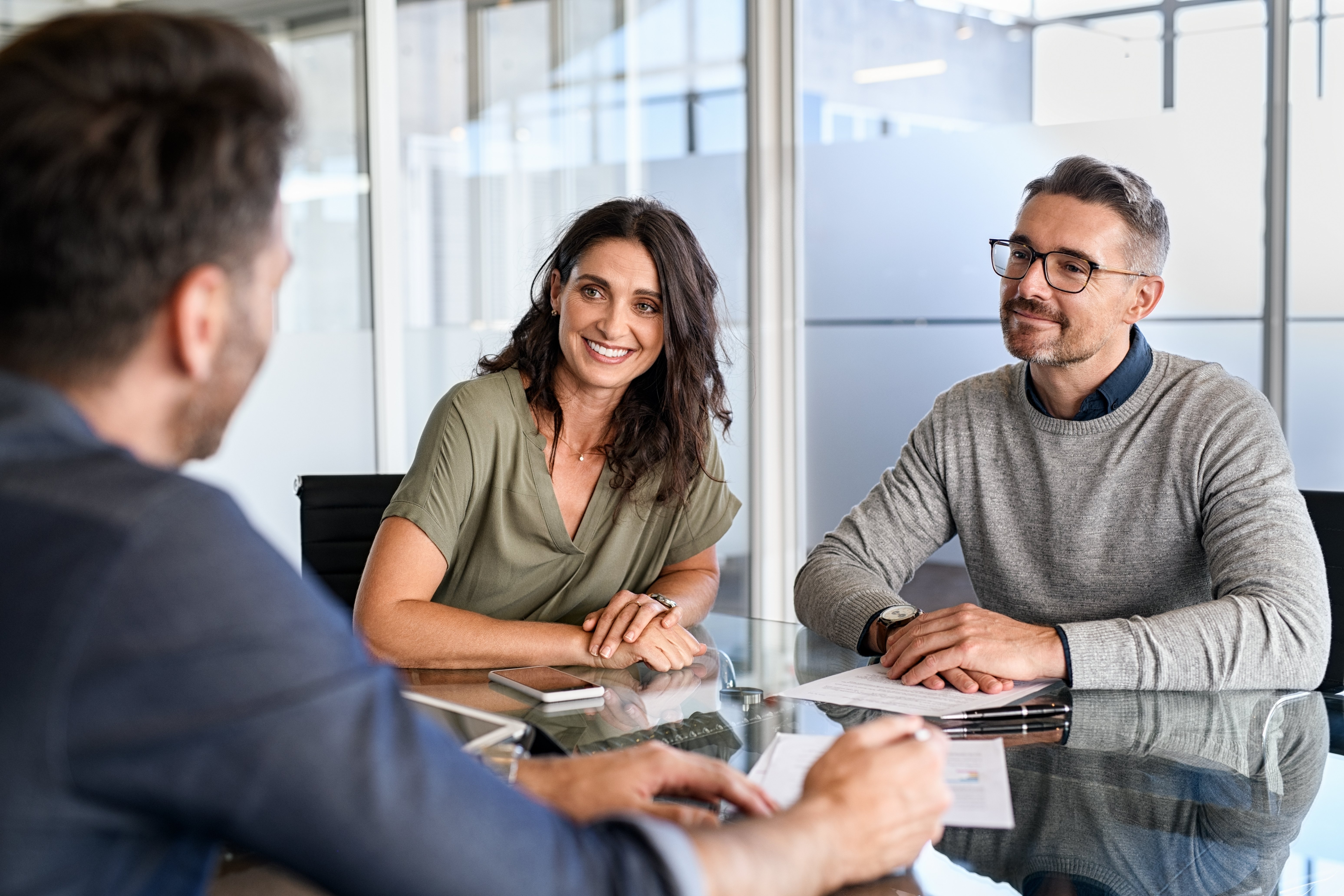 happy couple working with insurance broker