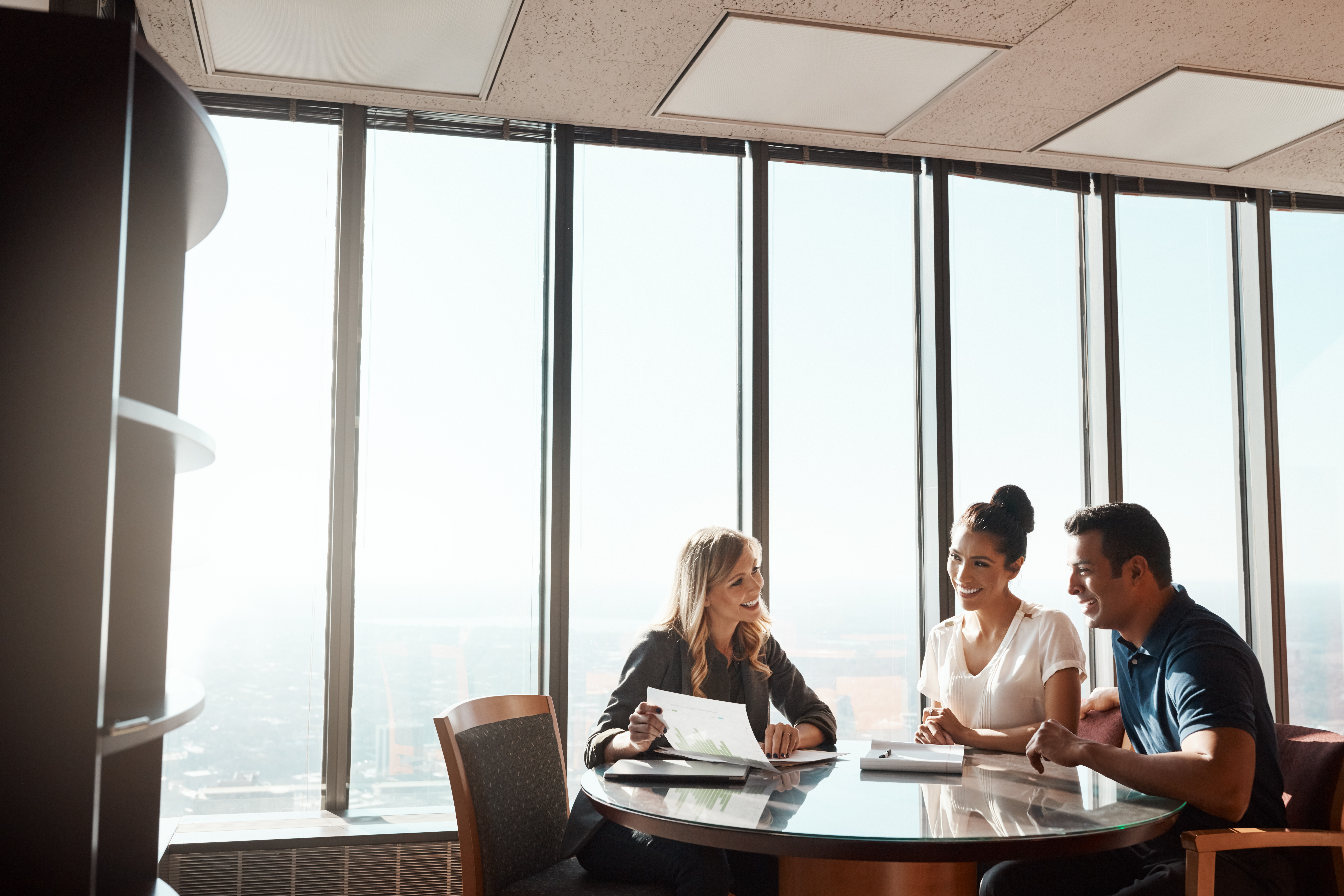 insurance broker meeting with smiling couple